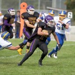 Steve Mullensky/for Peninsula Daily News Quilcene&rsquo;s Ace Elkins, runs upfield for a first down despite the grasp on his jersey by Crescent&rsquo;s McCabe Story during the Rangers&rsquo; 40-24 victory over the Loggers.