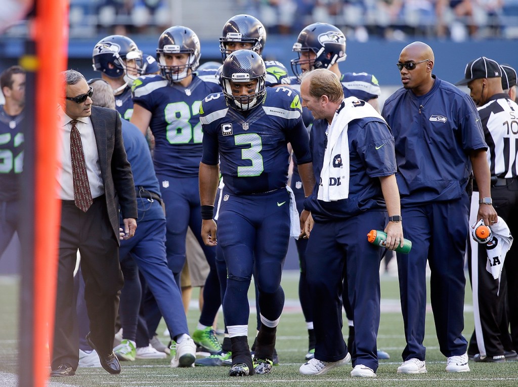 Seattle Seahawks quarterback Russell Wilson (3) is assisted off the field after being brought down against the San Francisco 49ers in the second half of an NFL football game, Sunday, Sept. 25, 2016, in Seattle. (AP Photo/Ted S. Warren)