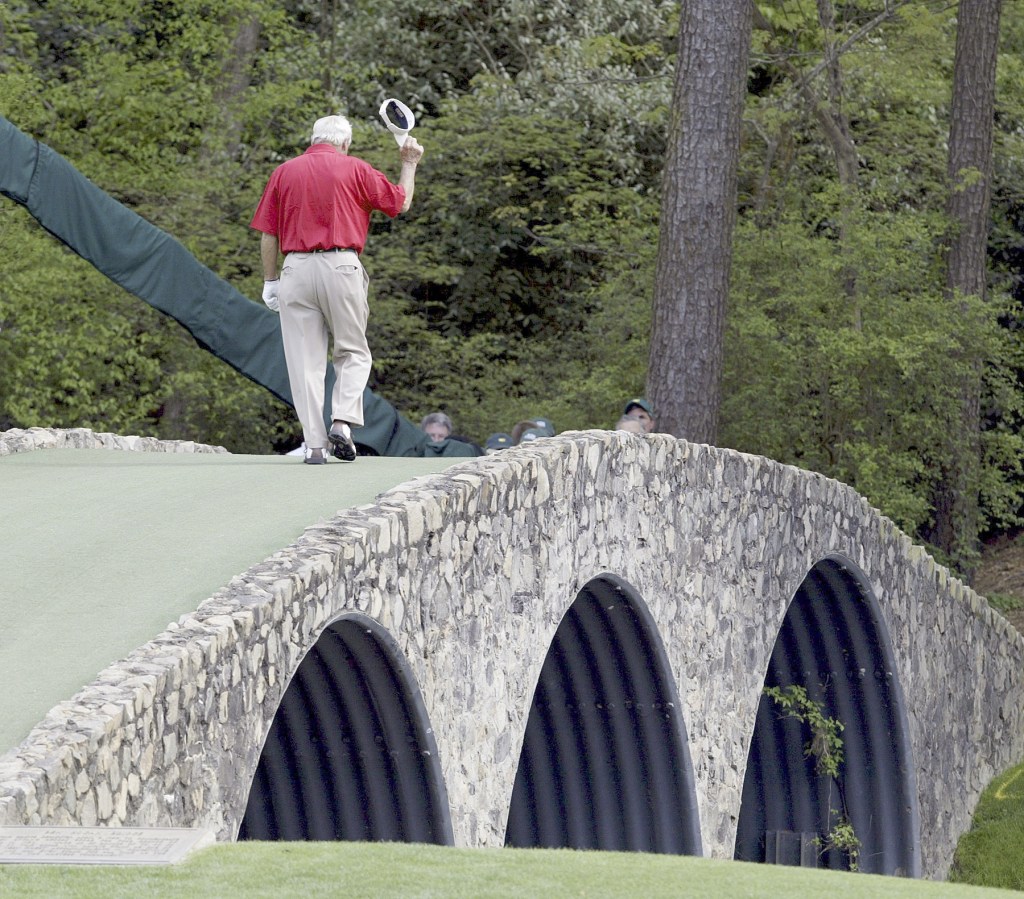 The Associated Press                                This April 9, 2004, file photo shows Arnold Palmer walking across the Hogan Bridge on the 12th fairway for the final time in Masters competition.