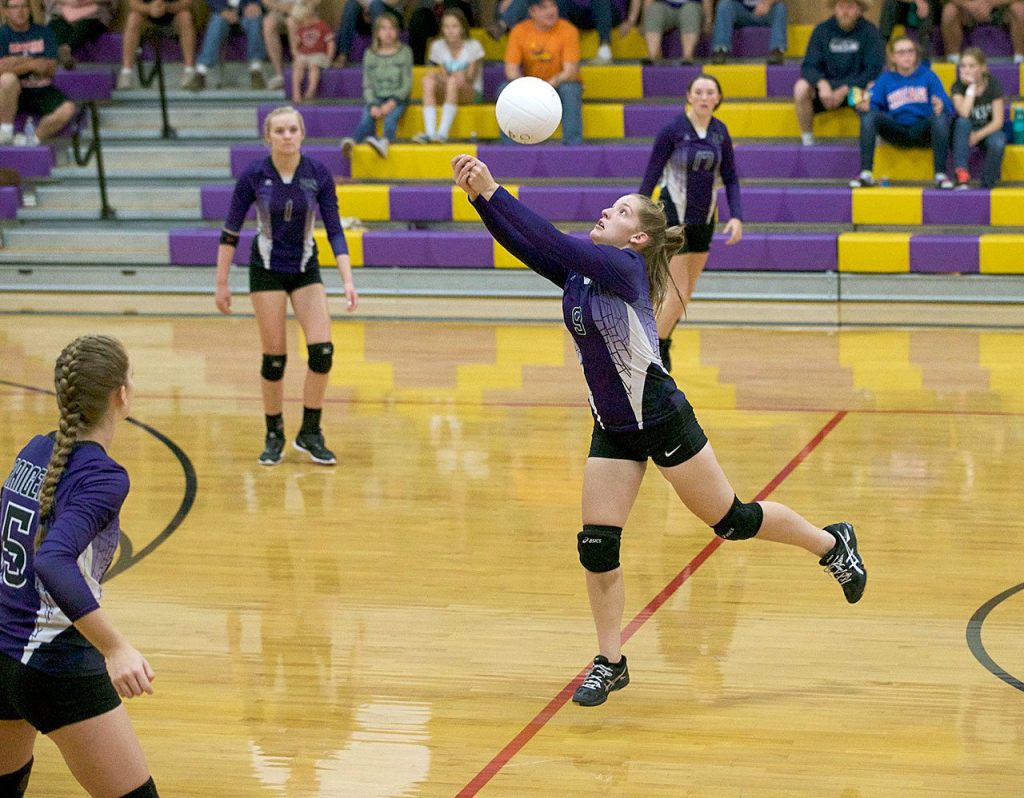 Steve Mullensky/for Peninsula Daily News Quilcene&rsquo;s McKenzie Kieffer (5), Emily Hitt (1) and Bailey Kieffer watch as Allison Jones hits a return during a game against the Chimacum Cowboys.