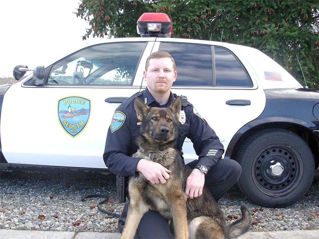 After nine years at the Sequim Police Department, K-9 officer Chase is hanging up his dog tags. He is pictured with Sgt. Mike Hill. (City of Sequim)
