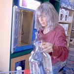 Roslyn Stevens of Chimacum fills bottles at the self serve bottled water station at the Port Townsend Co-Op. Port Townsend&rsquo;s water has been deemed safe to drink, but Stevens and many others choose the bottled option since it&rsquo;s free of the chemicals like chlorine that are used to purify local drinking water. (Cydney McFarland/Peninsula Daily News)