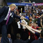 Republican presidential candidate Donald Trump shakes hands as he arrives to a campaign rally at Xfinity Arena of Everett on Tuesday in Everett. (Evan Vucci/The Associated Press)