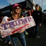 Marcyann Ritchie, of Snohomish holds her homemade sign supporting Republican presidential candidate Donald Trump as she waits in line Tuesday for a Trump rally in Everett. (Ted S. Warren/The Associated Press)