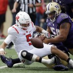 Rutgers quarterback Chris Laviano (5) fumbles the ball while being sacked by Washington&rsquo;s Vita Vea, right, and Azeem Victor in the first half of an NCAA college football game Saturday, Sept. 3, 2016, in Seattle. Rutgers recovered the ball on the play. (AP Photo/Elaine Thompson)
