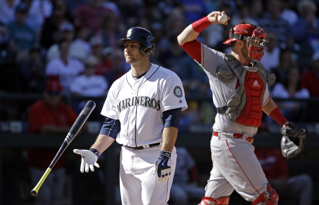 Seattle Mariners&rsquo; Chris Iannetta, left, flips his bat after striking out as Los Angeles Angels catcher Jett Bandy tosses the ball back to the mound in the seventh inning of a baseball game Sunday, Sept. 4, 2016, in Seattle. (AP Photo/Elaine Thompson)