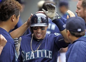 Seattle Mariners&rsquo; Leonys Martin is congratulated by teammates after scoring against the Texas Rangers during the sixth inning of a baseball game Monday, Sept. 5, 2016, in Seattle. (AP Photo/Elaine Thompson)