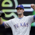 Texas Rangers starting pitcher Cole Hamels stretches after giving up a walk to the Seattle Mariners during the second inning of a baseball game Monday, Sept. 5, 2016, in Seattle. (AP Photo/Elaine Thompson)