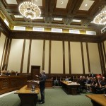 Alan Copsey, center, a deputy attorney general for the state of Washington, speaks during a hearing before the state Supreme Court regarding a lawsuit against the state over education funding on Wednesday in Olympia. (Ted S. Warren/The Associated Press)