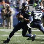Seattle Seahawks quarterback Russell Wilson, left, drops to pass against the Miami Dolphins in the first half of an NFL football game, Sunday, Sept. 11, 2016, in Seattle. (AP Photo/Elaine Thompson)