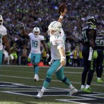 Miami Dolphins quarterback Ryan Tannehill (17) spikes the ball after scoring a touchdown against the Seattle Seahawks in the second half of an NFL football game, Sunday, Sept. 11, 2016, in Seattle. (AP Photo/Stephen Brashear)
