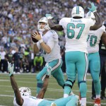 Miami Dolphins quarterback Ryan Tannehill, upper left, scores a touchdown against the Seattle Seahawks in the second half of an NFL football game, Sunday, Sept. 11, 2016, in Seattle. (AP Photo/Stephen Brashear)