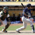 The Associated Press                                Seattle&rsquo;s Ketel Marte, right, drives in a run with a single during the ninth inning of Sunday&rsquo;s 3-2 win against Oakland.