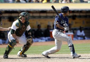 The Associated Press                                Seattle&rsquo;s Ketel Marte, right, drives in a run with a single during the ninth inning of Sunday&rsquo;s 3-2 win against Oakland.