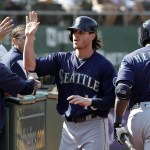 Seattle Mariners&rsquo; Ben Gamel, center, is high-fived in the dugout after scoring on a single by Ketel Marte during the ninth inning of a baseball game against the Oakland Athletics, Sunday, Sept. 11, 2016, in Oakland, Calif. (AP Photo/Marcio Jose Sanchez)