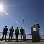 Maia Bellon, right, director of the state Department of Ecology, speaks at a news conference Thursday overlooking Elliott Bay in Seattle. (Ted S. Warren/The Associated Press)