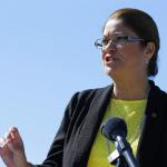 Maia Bellon, director of the state Department of Ecology, speaks at a news conference Thursday overlooking Elliott Bay in Seattle. Washington state environmental regulators finalized a new rule Thursday to limit greenhouse gas emissions from large polluters. (Ted S. Warren/The Associated Press)