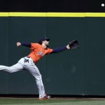 Houston Astros center fielder Jake Marisnick chases a run-scoring ground rule double by Seattle Mariners&rsquo; Norichika Aoki in the fourth inning of a baseball game, Sunday, Sept. 18, 2016, in Seattle. (AP Photo/Elaine Thompson)