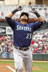 Seattle Mariners designated hitter Nelson Cruz celebrates his home run against the Minnesota Twins in the second inning of a baseball game Sunday, Sept. 25, 2016, in Minneapolis. (AP Photo/Bruce Kluckhohn)