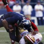 Seattle Seahawks quarterback Russell Wilson, top, is pulled down by San Francisco 49ers&rsquo; Eli Harold in the second half of an NFL football game, Sunday, Sept. 25, 2016, in Seattle. (AP Photo/Ted S. Warren)