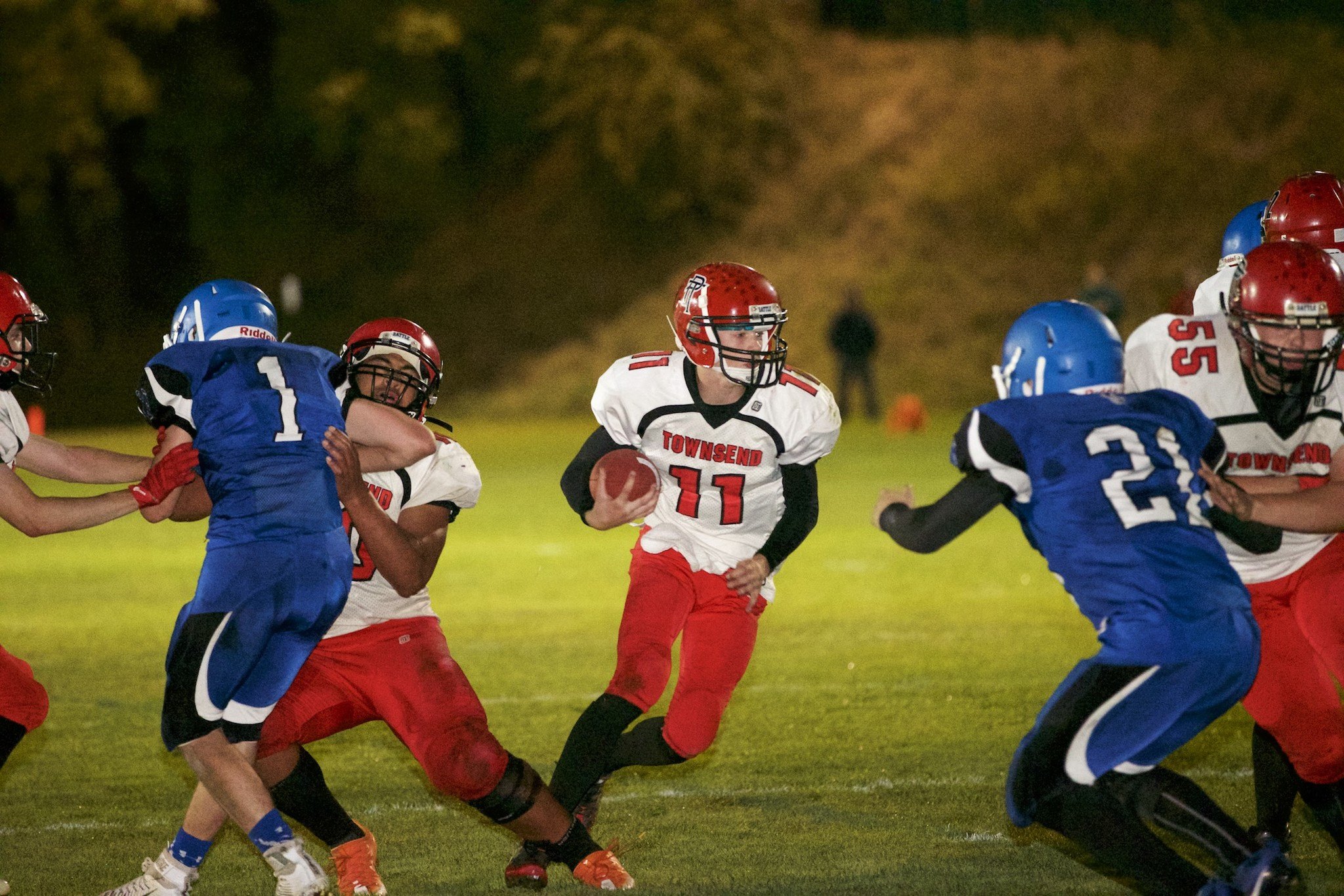 Steve Mullensky/for Peninsula Daily News Port Townsend&rsquo;s Berkley Hill finds an opening and rushes for a 2-yard touchdown against rival Chimacum Friday night at Memorial Field in Port Townsend. The Redhawks won 55-6.