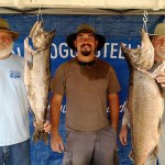 Mark Thompson, right, of Port Angeles, poses with the winning 32.4-pound king caught during the Restoring the Rogue Salmon Derby held last month on the Rogue River near Grants Pass, Ore. At far left is Thompson&rsquo;s teammate, high school classmate and fellow Marine, Carl Cole, and their guide Matt Judkins.