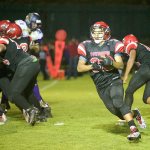Steve Mullensky/for Peninsula Daily News Port Townsend&rsquo;s Jacob Boucher carries the ball during the Redhawks&rsquo; 27-26 loss to Sequim.