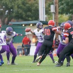 Steve Mullensky/for Peninsula Daily News                                Under pressure from Port Townsend&rsquo;s Detrius Kelsall (10) Sequim quarterback Riley Cowan (14) looks to throw during the Wolves&rsquo; 27-26 victory. Cowan completed 23 of 30 passes for 275 yards, four TDs and two interceptions.