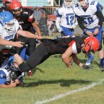 Lonnie Archibald/for Peninsula Daily News Neah Bay&rsquo;s Cole Svec stretches out for more yardage as he is being tackled By Chimacum&rsquo;s Matt Bainbridge (31) and Jordan Mason (72) While Neah Bay&rsquo;s Kenrick Doherty Jr. (1) looks on.
