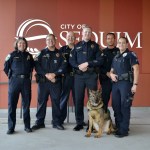 Chase the K-9 officer receives a proper send-off Monday on the night of his retirement from friends on the force, from left, Deputy Chief Sheri Crain, Sgt. Darrell Nelson, Chief Bill Dickinson, Sgt. Mike Hill, Officer Anthony Bush and Port Angeles Police Department Cpl. Kori Malone. (Matthew Nash/Olympic Peninsula News Group)