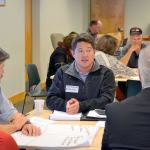 Caleb Anderson of Anderson Homes talks with his group about economic development strengths and weaknesses in the area Monday at the Clallam Transit Center. (Matthew Nash/Olympic Peninsula News Group)