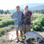 Salt Creek Farm owners Doug Hendrickson and Lee Norton with one of their goats that live on the farm. (North Olympic Land Trust)