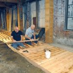 Don Perry, left, and Bill Huizinga install cedar planks last week for a walkway being built in the Port Angeles underground beneath the sidewalk on Laural Street in downtown Port Angeles. (Keith Thorpe/Peninsula Daily News)