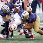Stanford running back Christian McCaffrey (5) is tackled by Washington linebacker Azeem Victor (36) and defensive lineman Elijah Qualls in the first half of an NCAA college football game, Friday, Sept. 30, 2016, in Seattle. (AP Photo/Ted S. Warren)