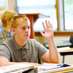 Bryson Rose raises his hand during 10th-grade English at Crescent High School on Monday. Crescent High School was recently recognized as a school of distinction. (Jesse Major/Peninsula Daily News)