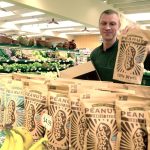 Port Townsend Co-Op employee Adam Carter stocks shelves at the store. (Cydney McFarland/Peninsula Daily News)