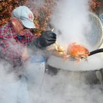 Julian McCabe helps pull cooked crab from a kettle on its way to the plate of a hungry festival-goer on Friday at the 15th annual Dungeness Crab and Seafood Festival in Port Angeles. (Keith Thorpe/Peninsula Daily News)