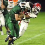 Keith Thorpe/Peninsula Daily News Port Angeles&rsquo; Rudy Valdez, left, fends off the defense of Renton&rsquo;s Nefetalai Finau in the second quarter on Friday night at Port Angeles Civic Field.