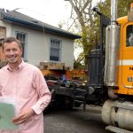 Joe Johnson of Johnson Family Properties NW stands in front of one of the homes floated in from Victoria on a barge Tuesday night. (Cydney McFarland/Peninsula Daily News)