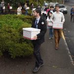 FILE - In this file photo taken Oct. 29, 2015, Carbon Washington campaign organizer Ben Silesky, left, leads a group of supporters and organization members into the Elections Office for the Washington Secretary of State in Olympia, Wash. to deliver signatures in support of putting Initiative 732 on the ballot. Voters in Washington state will weigh in on Initiative 732 in the 2016 election as they consider whether to approve the nation&rsquo;s first direct carbon tax on the burning of fossil fuels. (Steve Bloom/The Olympian via AP, file)