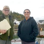 Anne Ricker, left, and Connie Gallant stand on Gallant&rsquo;s boat in Quilcene Marina. They are two of the community members that have been vocal about their opposition to any Port of Port Townsend plan that could limit public access to the marina and the beach next to it. (Cydney McFarland/Peninsula Daily News)