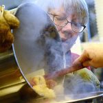 Volunteers turn 1,500 pounds of apples into applesauce for those in need