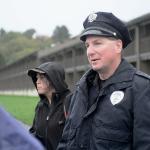 Viola Ware, program director of coordinated intake for Serenity House, and Sgt. Jason Viada of the Port Angeles Police Department let people on the Olympic Discovery Trail know about resources Serenity House provides. (Jesse Major/Peninsula Daily News)