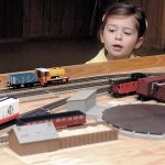 Three-year-old Harper Hilliker of Sequim examines a model train display during a model train show and swap at the Sequim Prairie Grange hall west of Sequim in 2015. The event, hosted by the North Olympic Railroaders, will feature several model train setups and a variety of vendors with items for sale or trade. (Keith Thorpe/Peninsula Daily News)
