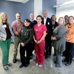 In back row from left are Dr. Jessica Colwell, Dr. Rob Eptsein, Isaac Ballou, CEO Michael Maxwell, COO Karen Paulsen, Tammy Reid and Heidi Wilson; in front row from left are Courtney Kacouros, Jenalee Attwood, Margie Warren and Kate Ballou. (Jesse Major/Peninsula Daily News)