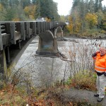 Tim Roening, assistant superintendent of maintenance for the Olympic Region of the state Department of Transportation, speaks on his phone during an inspection of the U.S. Highway 101 bridge over the Elwha River on Friday. The bridge has been undergoing work to shore up the bridge supports against scouring of the riverbed. (Keith Thorpe/Peninsula Daily News)