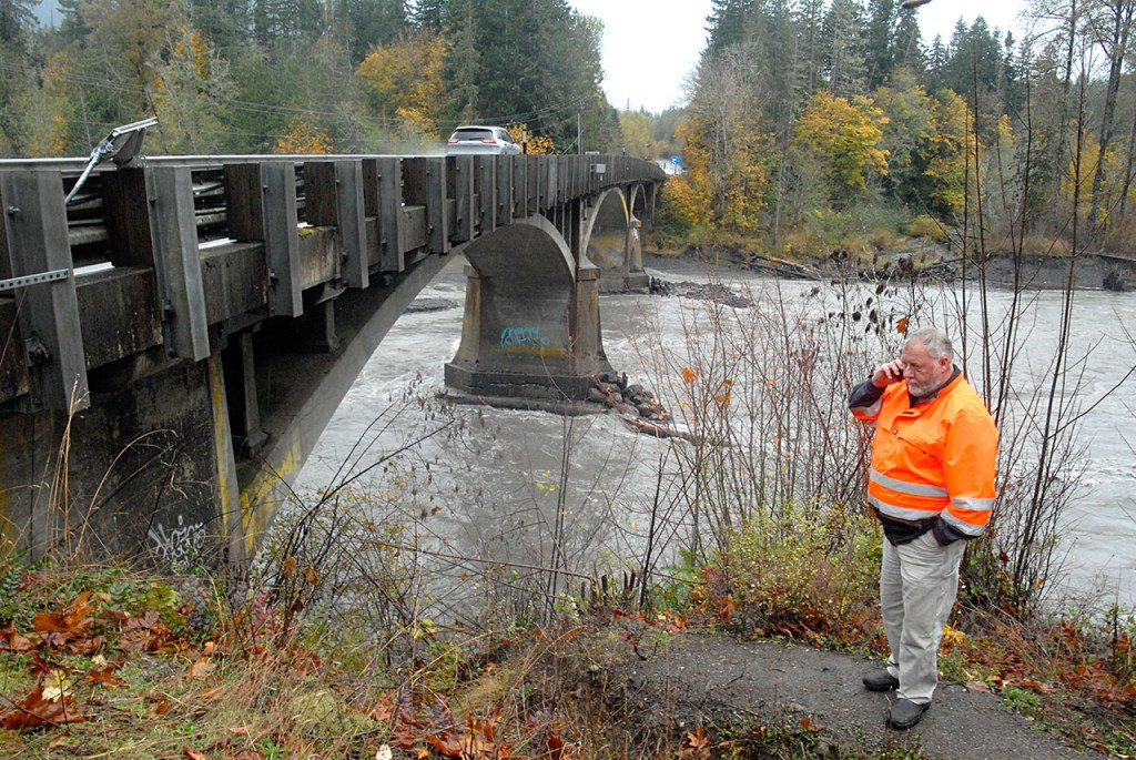 Tim Roening, assistant superintendent of maintenance for the Olympic Region of the state Department of Transportation, speaks on his phone during an inspection of the U.S. Highway 101 bridge over the Elwha River on Friday. The bridge has been undergoing work to shore up the bridge supports against scouring of the riverbed. (Keith Thorpe/Peninsula Daily News)