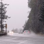 Traffic makes it way around a soggy U.S. Highway 101 at Sledge Hammer Point on Lake Crescent west of Port Angeles on Friday. (Keith Thorpe/Peninsula Daily News)