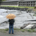 Jonathan May, left, and Asia Ladd, both of Port Angeles, watch as wind-driven waves crash onto Hollywood Beach in Port Angeles on Saturday, the result of a weather system that brought heavy rain and high winds to much of Western Washington. (Keith Thorpe/Peninsula Daily News)