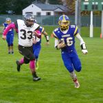 Dave Logan/for Peninsula Daily News                                Crescent quarterback K.C. Spencer (16) runs past Lummi&rsquo;s James Williams during the Loggers&rsquo; 50-6 loss to the top-ranked Blackhawks on Monday at Civic Field.